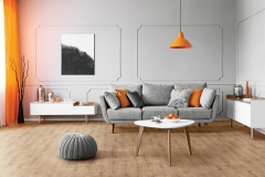 Stylish coffee table with kinck knacks in front of elegant couch with pillows